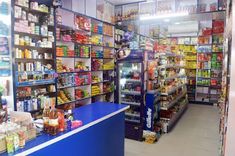 a store filled with lots of different types of food and drink bottles on shelves next to each other