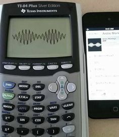 two calculators side by side on a table with an iphone next to them