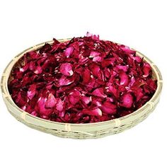 a basket filled with red flowers on top of a white table