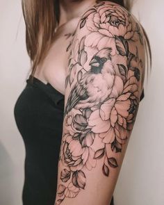 a woman's arm with flowers and a bird on it