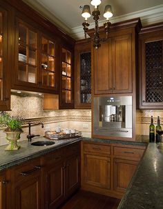 a kitchen with wooden cabinets and granite counter tops