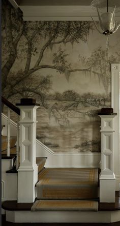 an elegant entry way with wallpaper and stairs