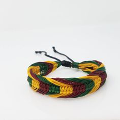 Handmade Rasta Bracelet with the colors of the Jamaican Flag This bracelet is Unisex Braided Bracelet Adjustable Cord - Fits Most Size Jamaican Style This beautiful bracelet is simply stunning. Our commitment to excellent quality ensures each piece is skillfully inspected.Order this today or browse our incredible selection of jewelry. FAST SHIPPING! Visit my Etsy Shop to see more Rasta Style Jewelry! Handmade Rasta Bracelets, Rasta Necklaces and Rasta Earrings. To visit my Etsy Shop Click here: Adjustable Multicolor Jubilee Bracelet, Adjustable Yellow Bangle For Gift, Adjustable Multicolor Band Bracelets, Adjustable Multicolor Band Bracelet, Rasta Bracelet, Rasta Style, Rasta Earrings, Rastafarian Culture, Africa Earrings