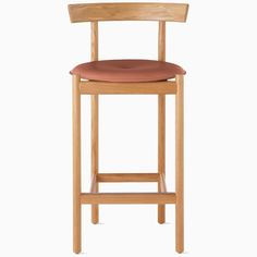 a wooden bar stool with a brown cushion on it's seat and backrest