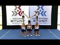 a group of young women standing on top of a tennis court holding hands in the air