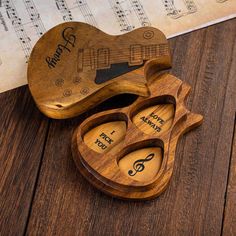 wooden music box shaped like an electric guitar with musical notes on the back and sides