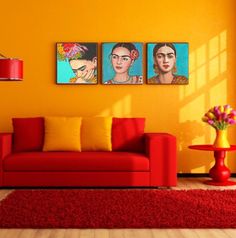 a living room with three paintings on the wall