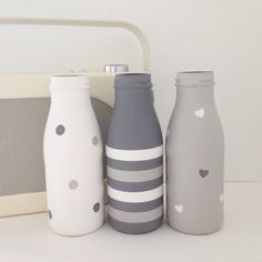 three gray and white bottles sitting next to each other