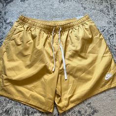 New With Tags Nike Standard Above The Knee Length Shorts. Gold Yellow Color With White Nike Logo. Mesh Lining. Size Xl. Awesome Shorts! Nike Beach Shorts With Pockets, Nike Shorts With Pockets For The Beach, Nike Beach Shorts With Elastic Waistband, Nike Shorts With Elastic Waistband For Beach, Nike Yellow Bottoms For Summer, Nike Yellow Summer Bottoms, Nike Beachwear Shorts, Nike Summer Beach Bottoms, Nike Casual Vacation Bottoms