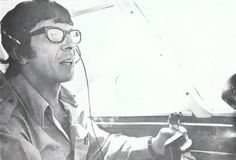 an old photo of a man wearing headphones and listening to music in a plane