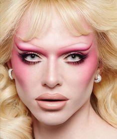 a woman with blonde hair and pink makeup