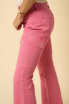 "Add a pop of fun to your wardrobe with our COLOR CARGO SLIM BOOT Pink Cargo Denim Pants. These slim boot cut pants feature a playful pink cargo design and side cut detailing. Stand out in style and comfort. (Seriously, they feel like a dream.)" - 100% Cotton- Non-Stretch Denim- Color Cargo Slim Boot- Front Zipper Fly- 7 pocketsModel is wearing size 3/25 Height 5'8Waist 28 1/2"Hip 37 1/2"Front Rise 10"Inseam 32" Style: Casual Print / Pattern: Pink Dye Denim Silhouette: Cargo Fit: Slim Embellishm Pink Utility Cargo Jeans With Side Pockets, Pink Stretch Cargo Pants For Spring, Spring Pink Stretch Cargo Pants, Pink Denim Bottoms With Cargo Pockets, Pink Denim Cargo Bottoms, Pink Denim Bottoms With Pockets, Spring Pink Bottoms With Cargo Pockets, Trendy Pink Cargo Pants With Side Pockets, Trendy Pink Pants With Side Pockets