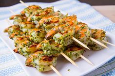 several skewers of food on a white plate