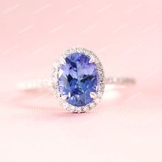 Gemstone: Tanzanite Metal: 925 Sterling Silver Finish Type: Choose From Above Options Ring Size: Choose From Above Options Gemstone Size: Oval 7X5 MM Gemstone Size: Round 1 to 1.2 MM White Zircon Gem Weight: Approx. 1.15 CTS Metal Weight: Approx. 4 Grams Code: JRX0091 Every Piece of Jewelry we make has a special meaning and story. We use the highest quality USA and Italy made materials like 14K Gold, 925 Sterling Silver, 14K Gold Vermeil, 14K Rose Gold Vermeil. We always use rhodium overlay over Oval Tanzanite Diamond Wedding Ring, Gift Tanzanite Ring With Halo Design, Tanzanite Halo Ring Jewelry, Tanzanite Halo Promise Ring, Tanzanite Halo Design Ring For Gift, Tanzanite Halo Design Ring As Gift, Tanzanite Halo Design Jewelry For Promise Ring, Tanzanite Halo Jewelry For Wedding, Tanzanite Halo Wedding Jewelry