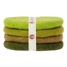 three pieces of green wool are stacked on top of each other with a white ribbon