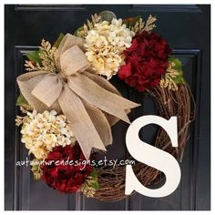 a wreath with flowers and a letter s on it