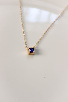 PRODUCT DESCRIPTION Chic and sophisticated, this Diane Necklace is inspired by the glamour of bygone eras. This opulent piece is crafted in 18k Gold-plated or 14k Gold-filled with metal and features a blue square-cut cubic zirconia pendant. Effortlessly elegant and pairs beautifully with day and evening ensembles. You are fine to shower in our gold-filled jewelry. Get it wet, wear it for life! A Dainty yet Elegant Necklace Water and Tarnish Resistant 14k Gold-filled with jeweler's brass (at leas Blue Stone Pendant, Elegant Necklace, Blue Square, Square Cut, Elegant Necklaces, Gold Filled Jewelry, Gold Pearl, Blue Stone, Necklace Designs