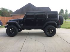 a black jeep parked in front of a house