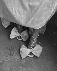 black and white photograph of woman's feet with bows on them