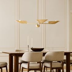 a dining room table with chairs and a chandelier