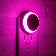 an electrical outlet with a purple light on it