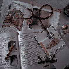 an open book with glasses and a stethoscope sitting on top of it