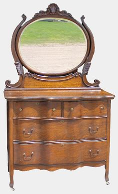 an old dresser with a mirror on top