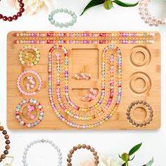 a wooden board with beads and rings on it