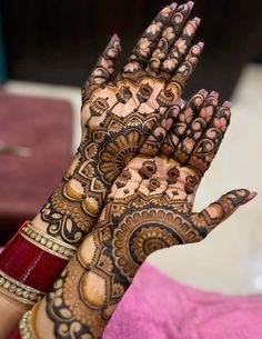 a woman's hands with hennap on it, showing the intricate design