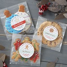 three packaged cookies in plastic bags on a wooden table with leaves and other holiday decorations