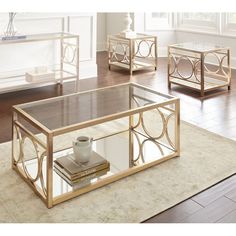 three coffee tables with glass top and metal frame, one has a cup on it