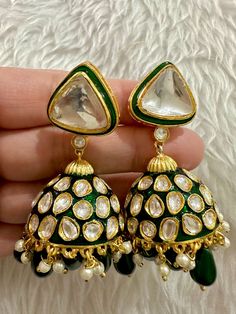 Elevate your jewellery collection with these exquisite Sabyasachi inspired uncut polki kundan designer earrings. Crafted from high-quality brass, these dangle/drop earrings exude elegance and sophistication. The designer brand and inspirational theme add a touch of luxury to your outfit, making them perfect for any occasion. With intricate detailing and a stunning design, these earrings are a must-have for any jewellery lover. Ideal for those who appreciate artistry and craftsmanship, these earrings are sure to make a statement. Add these earrings to your collection and enjoy a timeless piece of jewellery that you can cherish for years to come. Kundan Meenakari Jhumkas Drop Earrings, Kundan Jhumkas With Meenakari In Drop Earrings Shape, Kundan Meenakari Jhumkas, Green Kundan Jhumkas Drop Earrings, Festive Kundan Jhumka Drop Earrings, Kundan Cutdana Dangle Jhumkas, Bollywood Meenakari Drop Jhumkas, Heavy Kundan Jhumkas Drop Earrings, Festive Kundan Teardrop Earrings