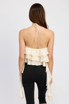 FINAL SALE Ivory halter top with a rosette detail and cascading ruffles. Ruffles can be tied at back or worn loose. 85% rayon 15% polyester // Hand wash cold // Made in China