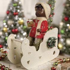 a figurine is sitting on top of a sleigh