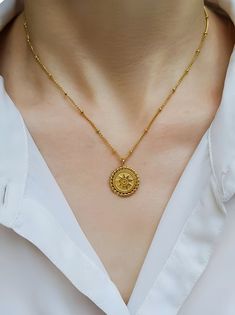 18K Gold Sunburst Coin Pendant Necklace, Sun Pendant Necklace, Boho Style Dainty Necklace, Gold Jewellery, Gift for Her, Coin Pendant, Gift for Her       Extra thick PVD gold plating of 1.5 microns - much thicker than standard plating which starts from 0.03 microns. When looked after, this piece can last for quite a few years.       Featuring a sunburst coin pendant, this necklace looks chic layered with your other favourites or worn on its own. Crafted from 18k gold-plated stainless steel.       Material: 316L Stainless Steel, 18K PVD Gold Plating    Length: 40cm with 5cm Extender    Pendant: 2cm    Clasp: Lobster Clasp    Waterproof and tarnish resistant.    Nickel & Lead-Free.       Add these to your collection today! You'll be wearing them every day!    Free tracked postage is included Dainty Necklace Gold, Necklace Sun, Gold Sunburst, Sun Pendant, Coin Pendant Necklace, Layered Jewelry, Jewellery Gift, Necklace Boho, Looks Chic