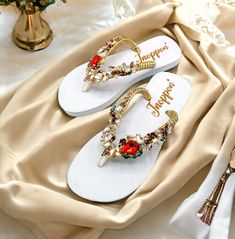 Description The beautiful rhinestone and customizable Flip Flops for the beach brides, bridesmaids, vacation, honeymoon or any occasion you desire to look gorgeous. Perfect in any outfit! Being unique and stunning on design, these flip flops must be your must-have item! The sandal is anti-slip, comfortable and durable as it is made from high quality rubber from the South of Thailand, where is famous for the best rubber tree. Moreover, the crystals are decorated on the sandal with effective adhesive glue and knitting threads by hand stitching. Don't worry when you walk on the beach or use it in the rainy season. For anyone who loves a real handmade product, don't miss it out! Product Description: - Thailand High-Quality Rubber Sole - Luxury Crystals/Rhinestones  - High-quality PU gold threa Summer Wedding Shoes With Rhinestones And Round Toe, Summer Wedding Shoes With Rhinestones, Embellished Round Toe Summer Wedding Shoes, Embellished Round Toe Wedding Shoes For Summer, Embellished Sandals For Beach Party, Embellished Sandals For Beach Season Parties, Gold Rhinestone Flip Flops For Vacation, Elegant Beach Wedding Shoes With Round Toe, Spring Party Embellished Flip Flops