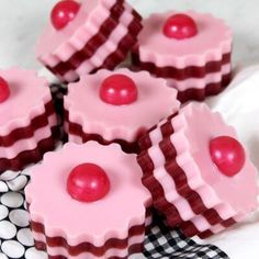 some pink cupcakes on a black and white napkin