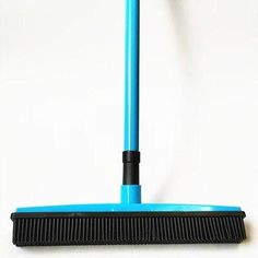 a blue dust mop sitting on top of a white floor next to a black handle