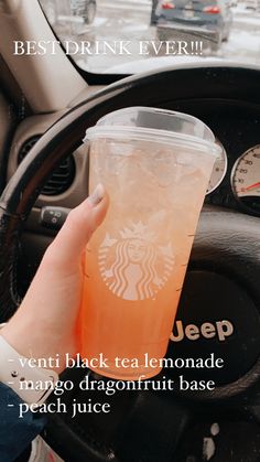 a person holding a drink in their hand and driving a car with the words best drink ever