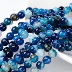 several blue and white beads on a plate