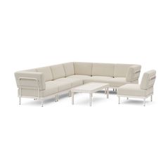 a white sectional couch with two chairs and a coffee table in front of it on a white background