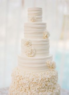 a white wedding cake with flowers on it