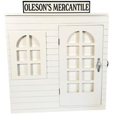 a white doll house with two windows and a sign that says nelson's mercantile