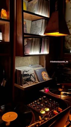 an old record player is sitting in front of some books