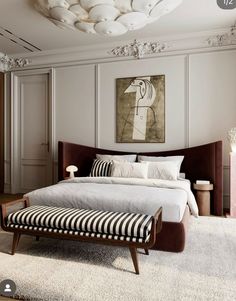 a bedroom with a large bed and white walls