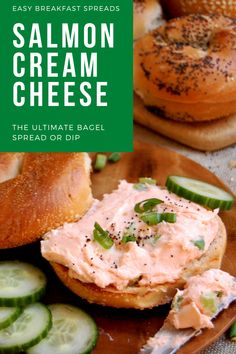 salmon cream cheese on bagel with cucumbers and pickles in the background