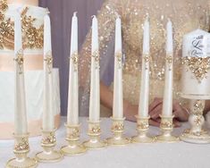 a table topped with lots of white candles