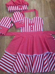 a red and white striped dress with matching bonnets on the headband is laying on the floor