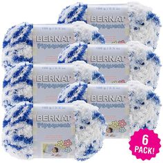 four bernat blue and white yarn balls with the label on top, in front of them