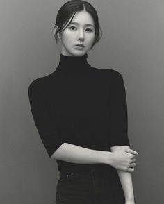 black and white photograph of a woman with her arms crossed